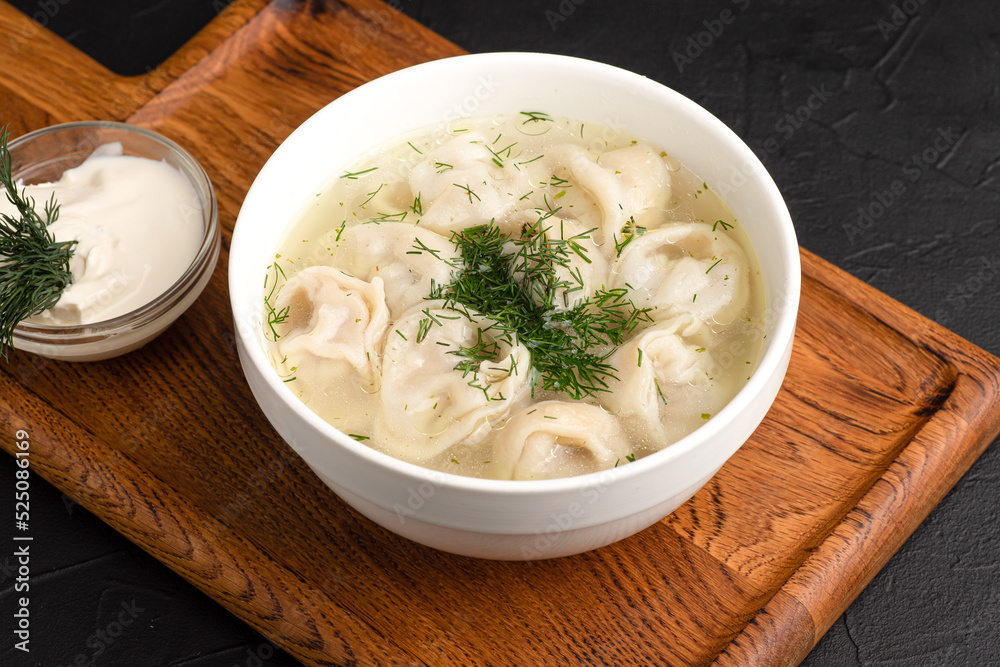 soup with dumplings, soup with sour cream, side view black background soup with dumplings, soup with sour cream, side view black background