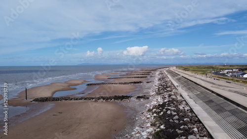 Aerial view of the beach with waves and a blue sky background with clouds. Taken in Fleetwood Lancashire England. 