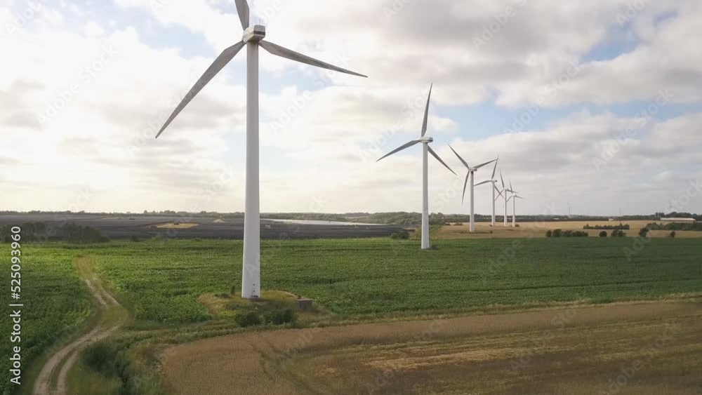 Row Of Wind Turbines Generating Electricity On Wind Farm. Renewable Energy Technology. ascending shot Row Of Wind Turbines Generating Electricity On Wind Farm. Renewable Energy Technology. ascending shot