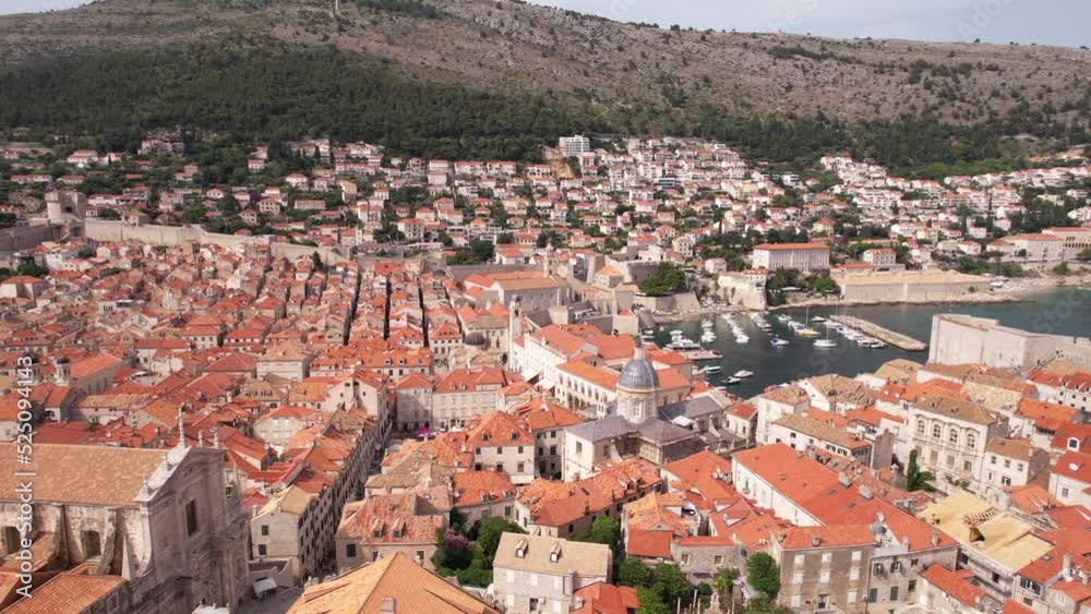 Dubrovnik Old Town, Croatia. Aerial View of City Buildings, Walls and Harbor on Sunny Summer Day, Revealing Drone Shot Dubrovnik Old Town, Croatia. Aerial View of City Buildings, Walls and Harbor on Sunny Summer Day, Revealing Drone Shot