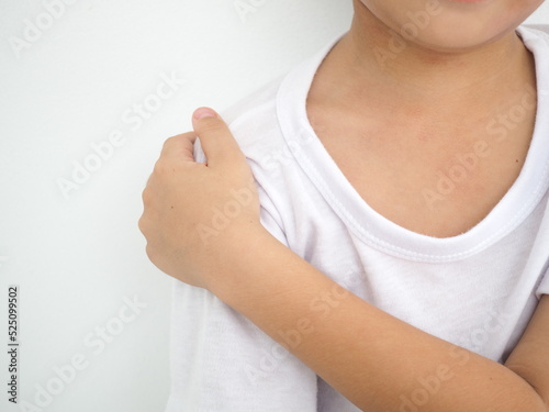 Little boy with pain in shoulder on white background. closeup photo, blurred. photo