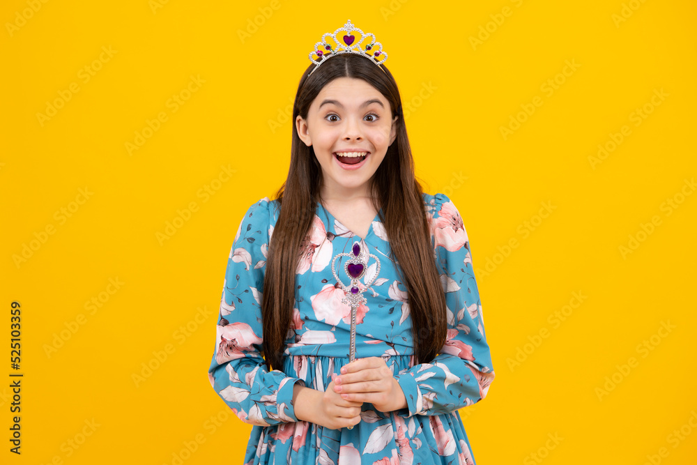 Portrait of happy girl princess in tiara holding magic wand. Teenager queen with golden crown. Portrait of happy girl princess in tiara holding magic wand. Teenager queen with golden crown.