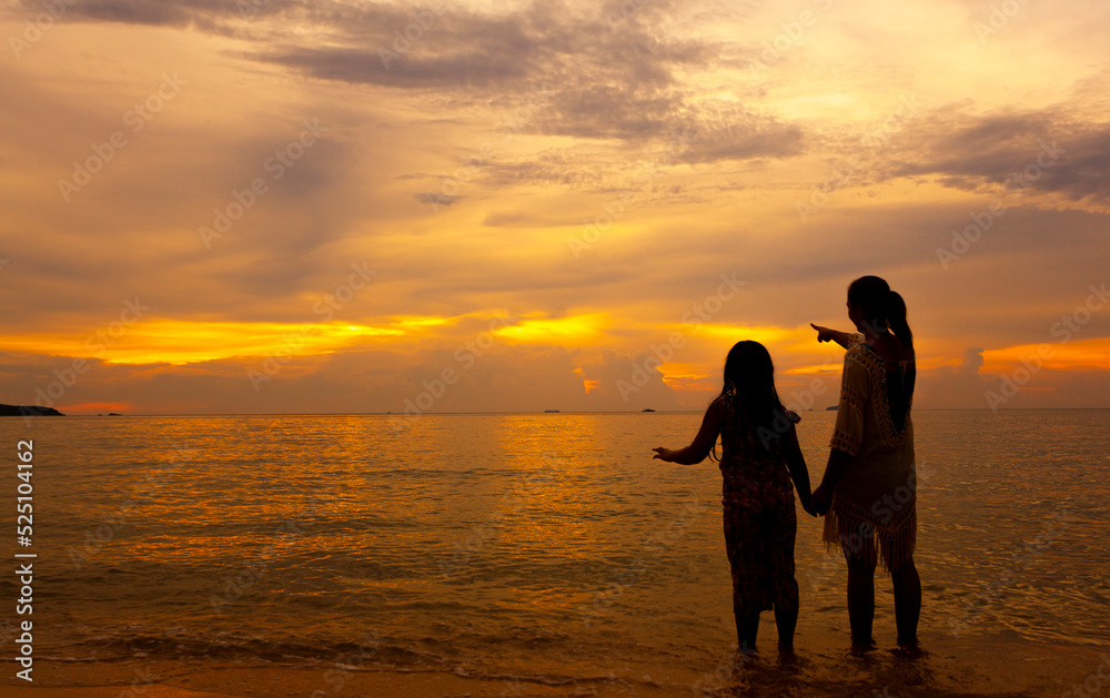 Women and children traveling to the sea during the high season invite each other to look at the yellow sky.