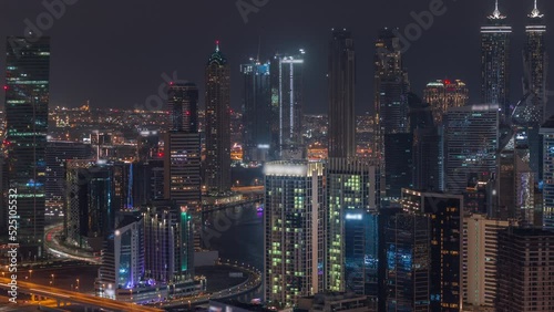 Wallpaper Mural Skyline with modern architecture of Dubai business bay towers day to night transition timelapse. Aerial view with canal and construction site after sunset with colorful sky Torontodigital.ca