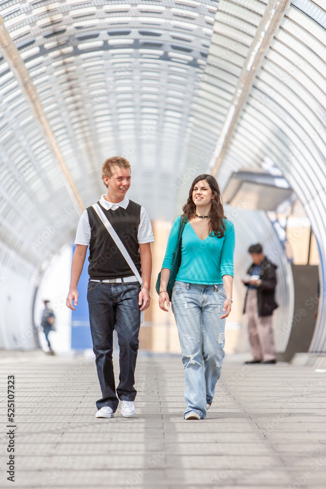 Teenage Students, friendly talk. College friends walking together on their way to school. From a series of related images.