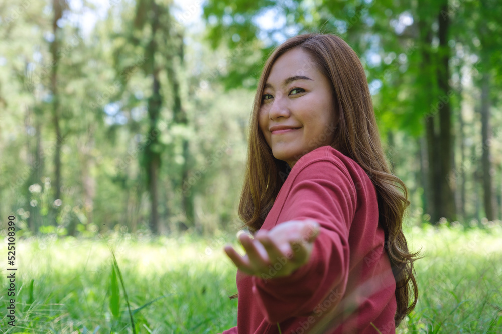 A beautiful asian woman holding hands and leads into the park for follow me concept
