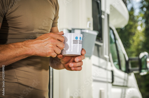 Men Staying with Cup of Hot Tea in Front of His Camper Van