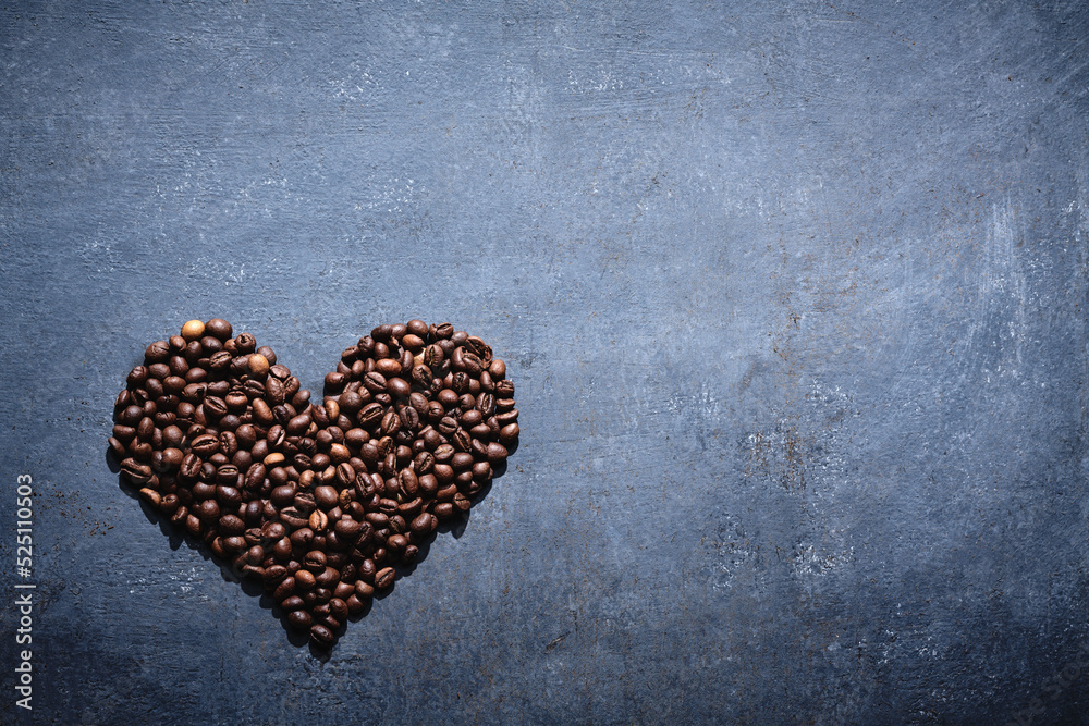 Roasted coffee beans in the shape of a heart on a gray background, love coffee