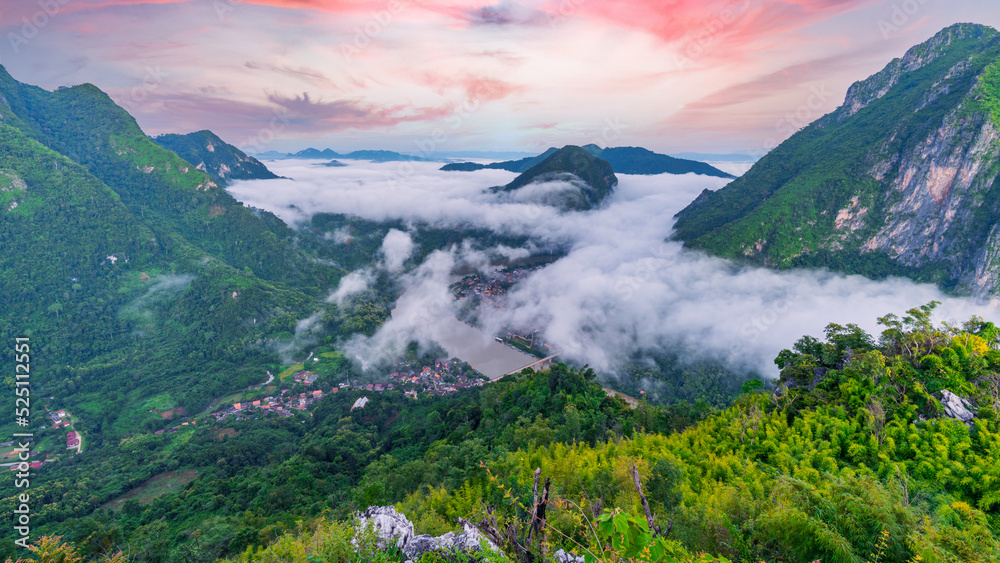  Viewpoint of Nong Khiaw - a secret village in Laos. Stunning scenery of limestone cliff valley covered with green rainforest jungle mysterious clouds.