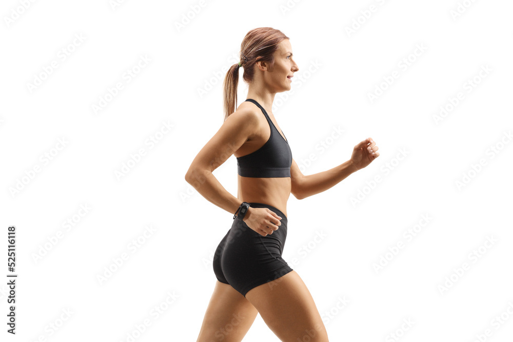 Profile shot of a strong young woman in sportswear running Profile shot of a strong young woman in sportswear running