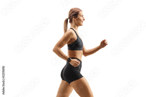 Profile shot of a strong young woman in sportswear running