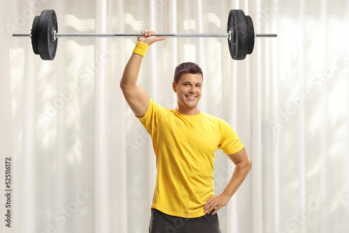 Young fit man lifting weigths at home