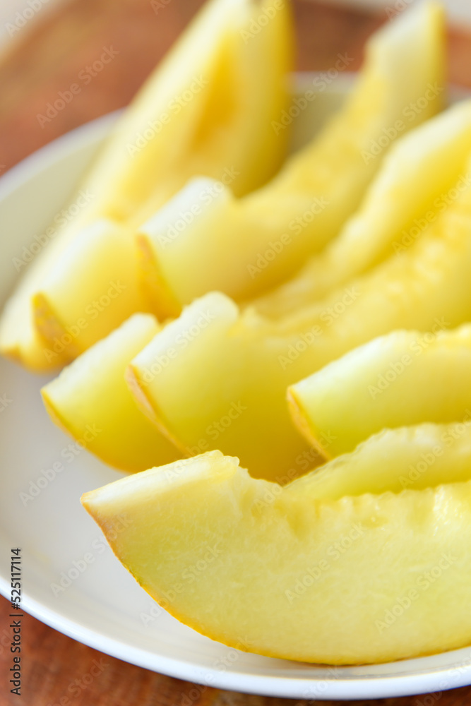 a plate full of sliced melon on a wooden board, the concept of fresh fruit and healthy food a plate full of sliced melon on a wooden board, the concept of fresh fruit and healthy food
