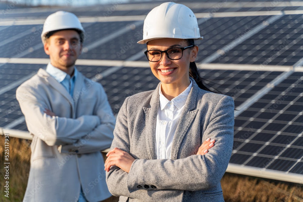 Beautiful Caucasian female standing in front of the solar panel Beautiful Caucasian female standing in front of the solar panel