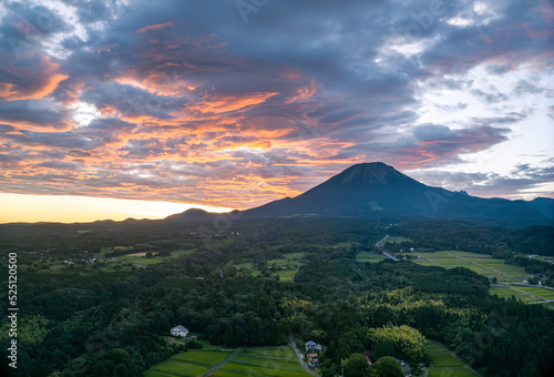 Sunrise on farmhouses dotting rural landscape at base of Mt. Daisen