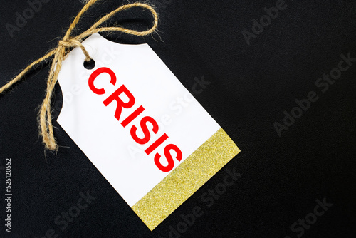 The inscription crisis on the tag or price tag for sale. The concept of the crisis in the world and the departure of companies from the country