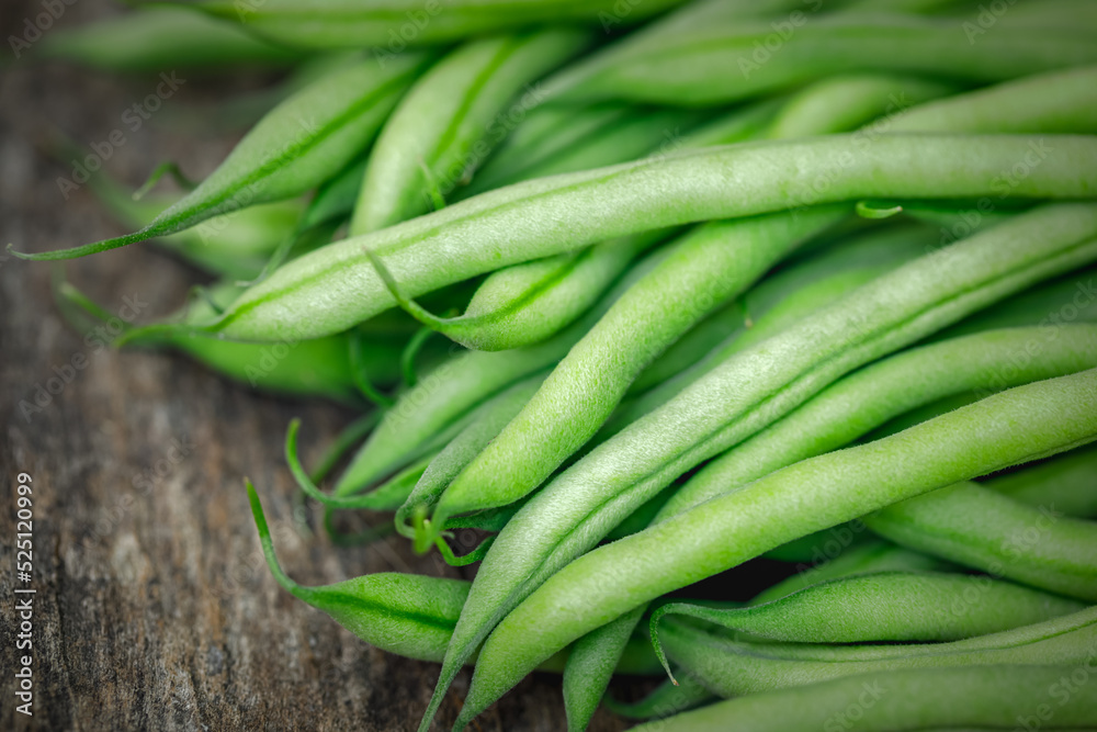 Bunch of organically grown 'Maxibel' French filet green beans harvested from a home garden on a rustic wooden table Bunch of organically grown 'Maxibel' French filet green beans harvested from a home garden on a rustic wooden table