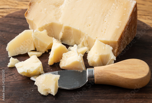 Artisanal Tulha cheese from Brazil with pieces over wooden table photo