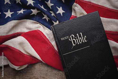 Christian Holy Bible placed on a vintage American flag