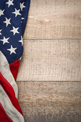 Vintage American flag left border on a rustic wooden background in vertical formation