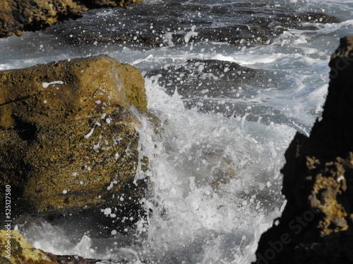 Ocean wave splashing against rocks
