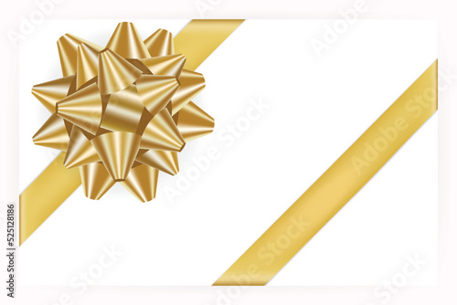 Golden bow and ribbons place on corner of paper with shadow 