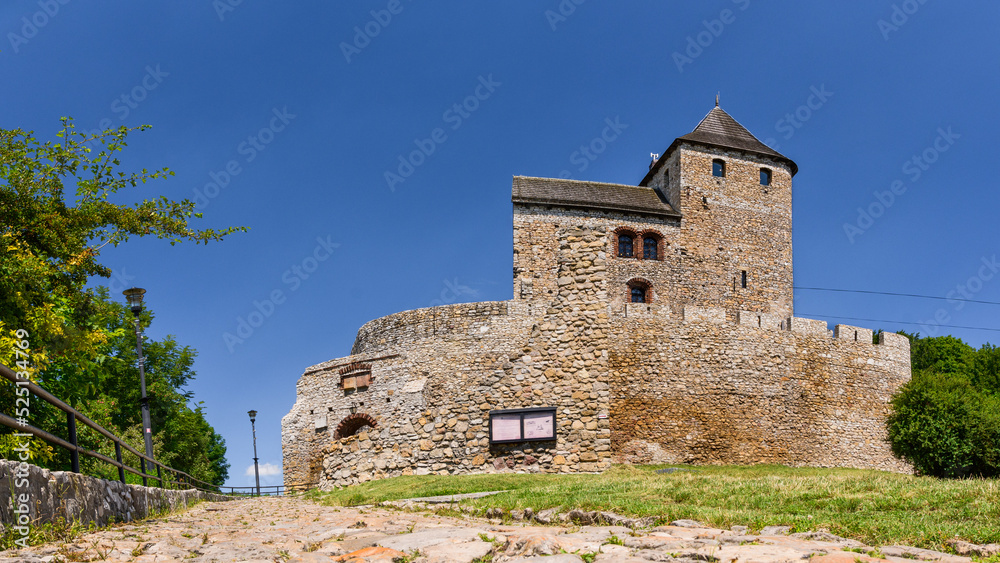Castle in Bedzin, a castle situated on a slope, is an example of defensive construction from the 14th century. Front view of the castle on a sunny summer day.