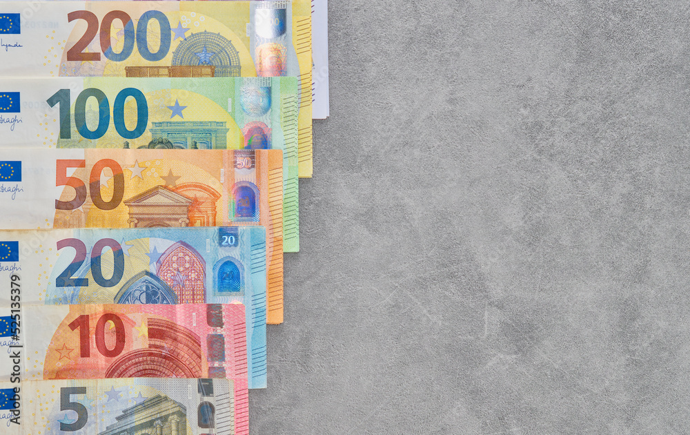 Euro banknotes are laid out on gray background, top view of euro ...