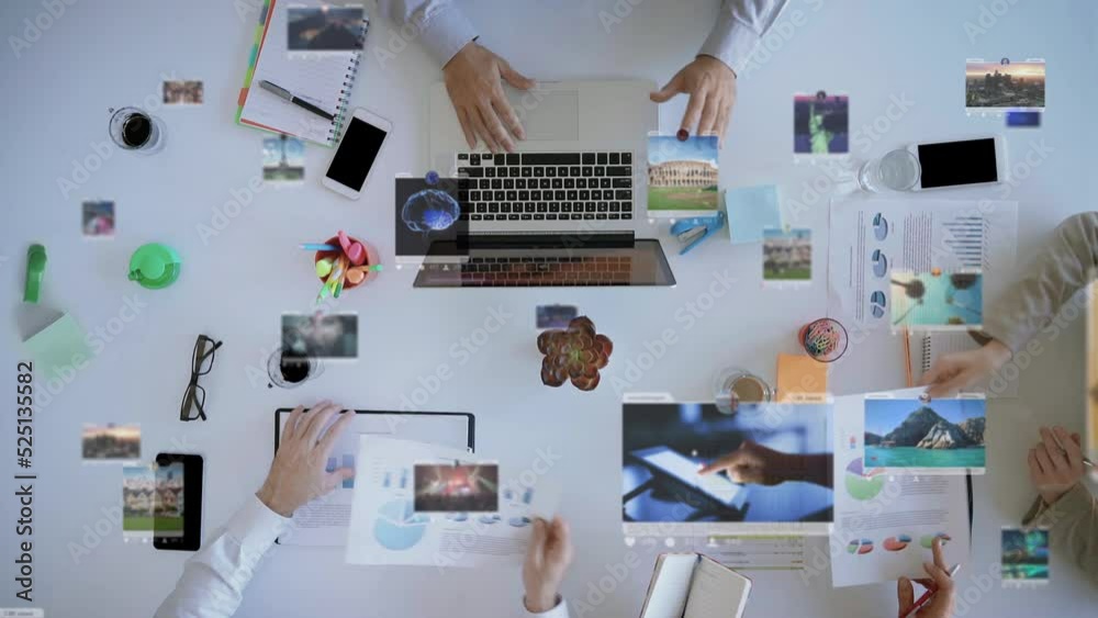 Overhead View Team of Young Businesspeople Brainstorming Working on Startup Business Solution Viewing Graph Statistics Using Tablet Laptop Technology with Social Media Holographic Display.