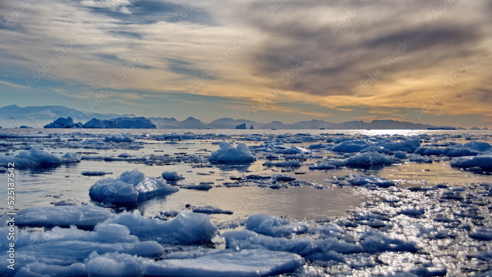 Icebergs floating in the bay at sunset, in Cierva Cove, Antarctica Icebergs floating in the bay at sunset, in Cierva Cove, Antarctica