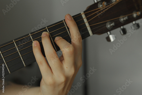 person playing guitar chord