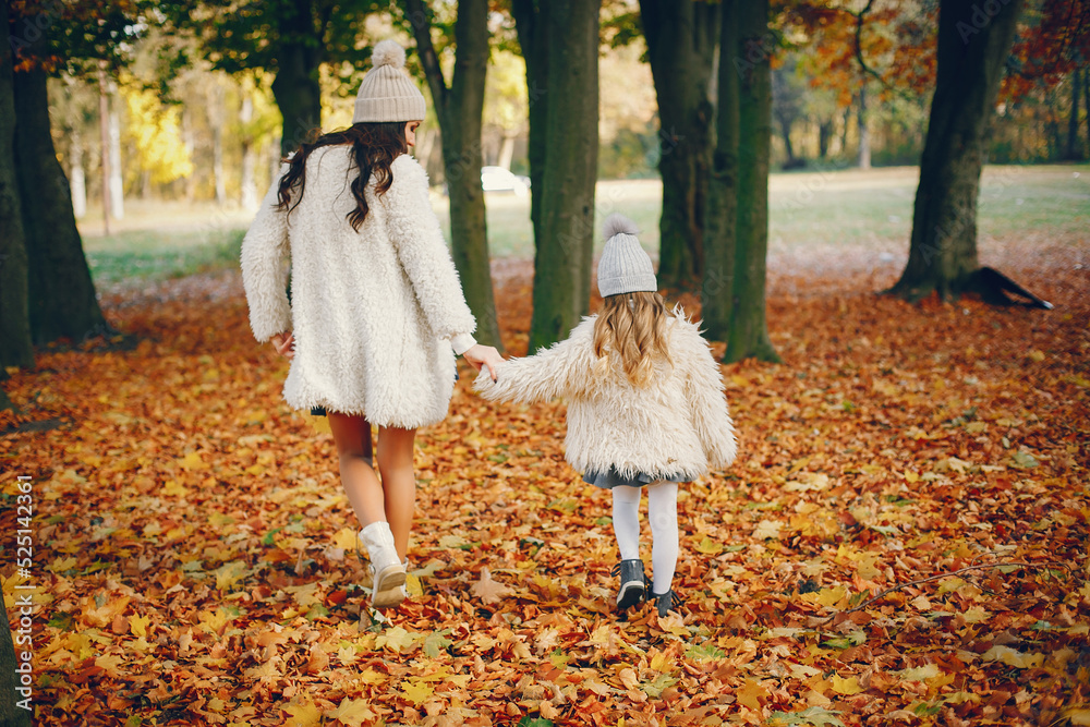 Cute and stylish family in a autumn park