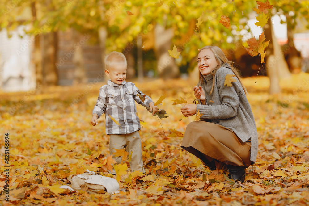 Mother with little son playing in a autumn field Mother with little son playing in a autumn field