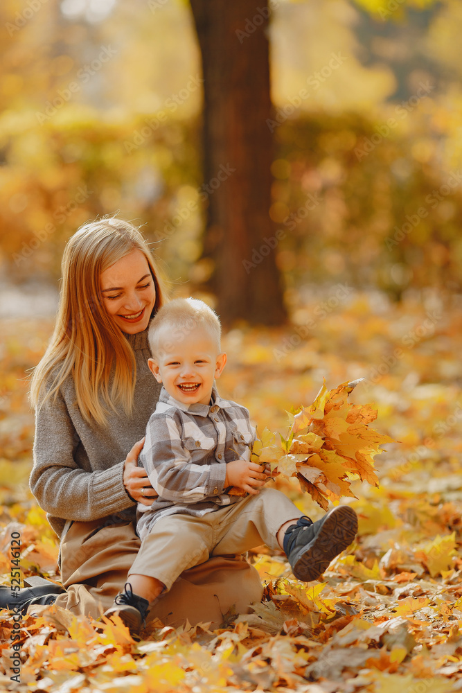 Mother with little son playing in a autumn field Mother with little son playing in a autumn field