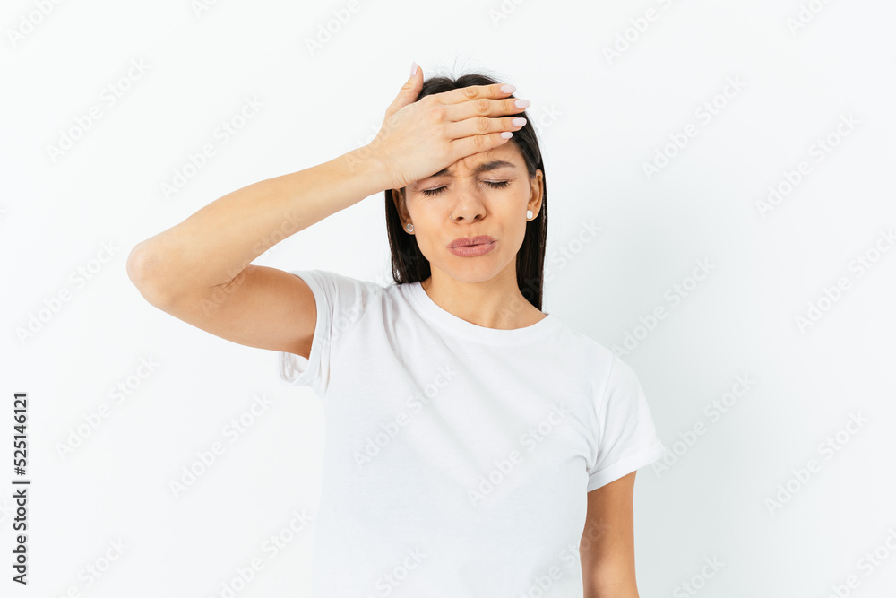 Young brunette woman suffering from terrible headache Young brunette woman suffering from terrible headache