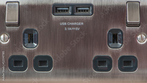 UK brushed steel double socket with usb charger. Close up view.