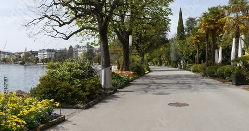Montreux, Switzerland. Panorama of the promenade of Lake Geneva in spring with palm trees and flowers.
