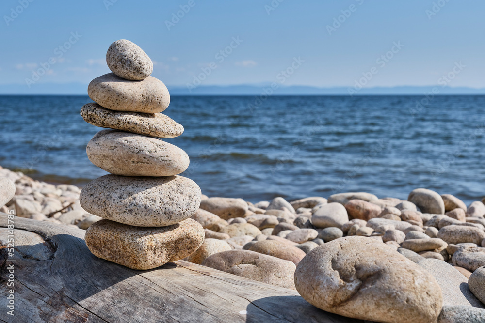 Pyramid of stones on shore of Barguzin Bay, Lake Baikal, Zabaikalsky National Park, Russia. Pyramid of stones on shore of Barguzin Bay, Lake Baikal, Zabaikalsky National Park, Russia.