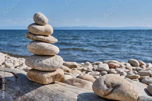 Pyramid of stones on shore of Barguzin Bay, Lake Baikal, Zabaikalsky National Park, Russia.