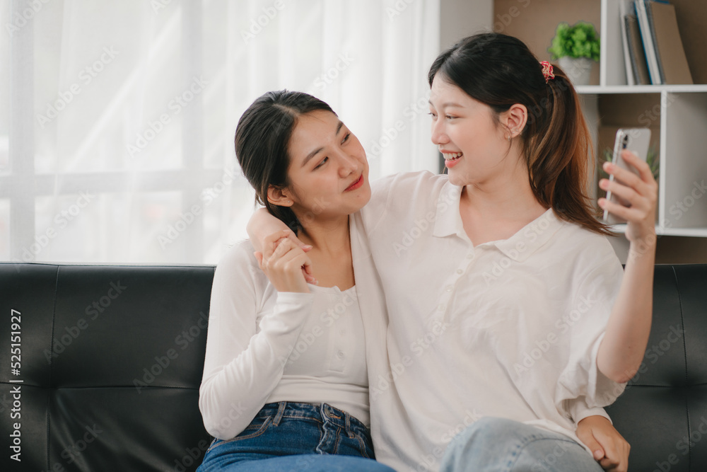 Asian woman happy holding laptop phone sitting sofa smiling good mood indoors indoors Asian woman happy holding laptop phone sitting sofa smiling good mood indoors indoors