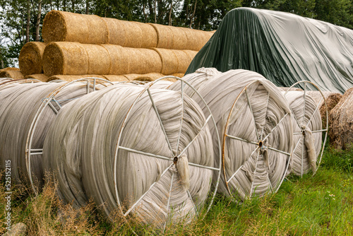 Many haystacks, blocks of hay, bales, stack of hay, rectangular bales on the field