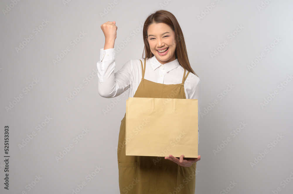 Portrait of young asian woman wearing apron over white background studio, cooking and entrepreneur concept Portrait of young asian woman wearing apron over white background studio, cooking and entrepreneur concept