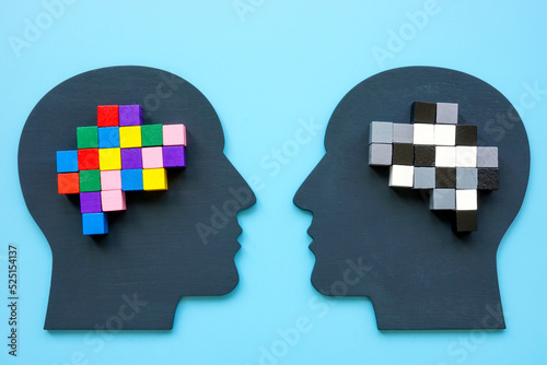 Positive and negative thinking concept. Heads and brain from colored cubes. photo