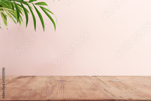 Murais de parede wooden table in front of interior wall and tropical green plant background