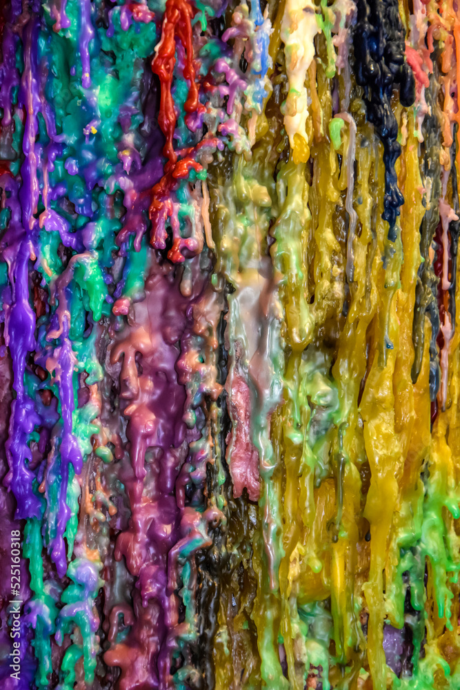 Abstract multicolored background of streaks of wax candles. Stripes of different colors. Close-up. Selective focus.