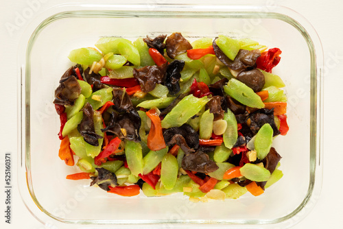 Stir fried celtuce (stem lettuce) with wood ear mushrooms (mun) in glass container - Chinese cuisine. photo