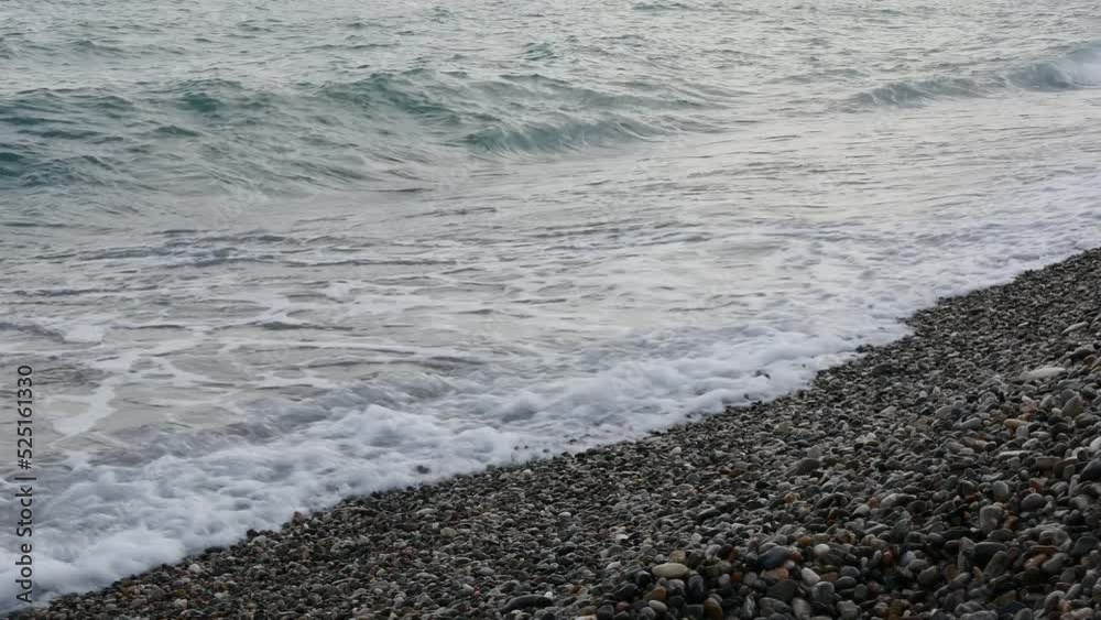 Sea waves beat the shore at sunset. Sea waves beat the shore at sunset.