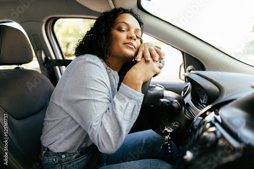 Wallpaper Mural Young and cheerful woman enjoying new car hugging steering wheel sitting inside. Woman driving a new car. Torontodigital.ca