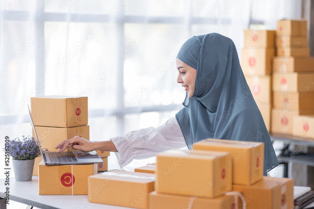 Muslim Young Asian business woman startup sme small business entrepreneur SME distribution warehouse with parcel mail box. Muslim girl SME Online marketing and product packaging and delivery service. Muslim Young Asian business woman startup sme small business entrepreneur SME distribution warehouse with parcel mail box. Muslim girl SME Online marketing and product packaging and delivery service.