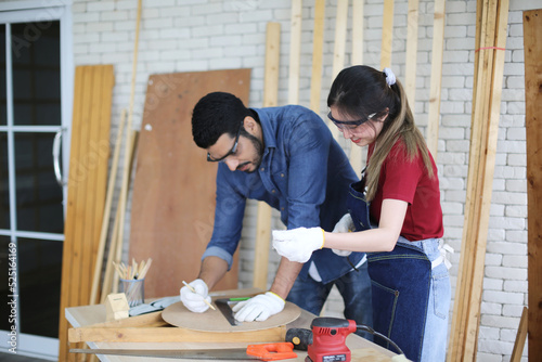 Carpenter grinding joinery product with carvings, finishing woodwork at the carpentry manufacturing